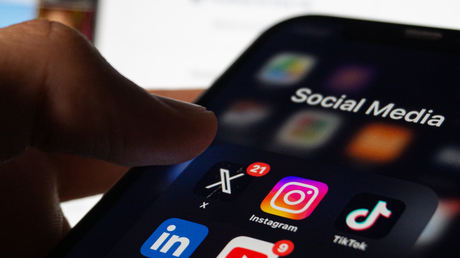 Person holding a smartphone showing social media and brand engagement apps