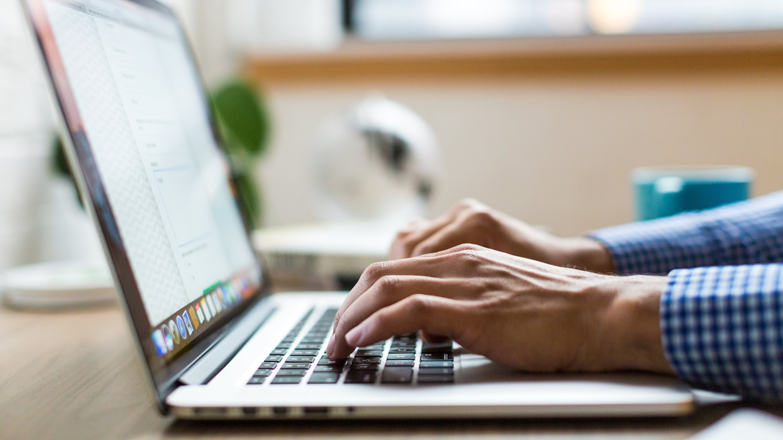 Professional typing on a laptop while managing an email marketing campaign